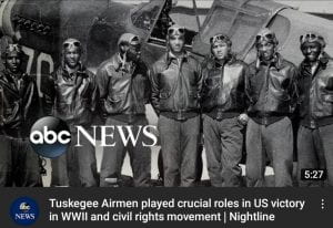 Group of Tuskegee Airmen in front of an airplane